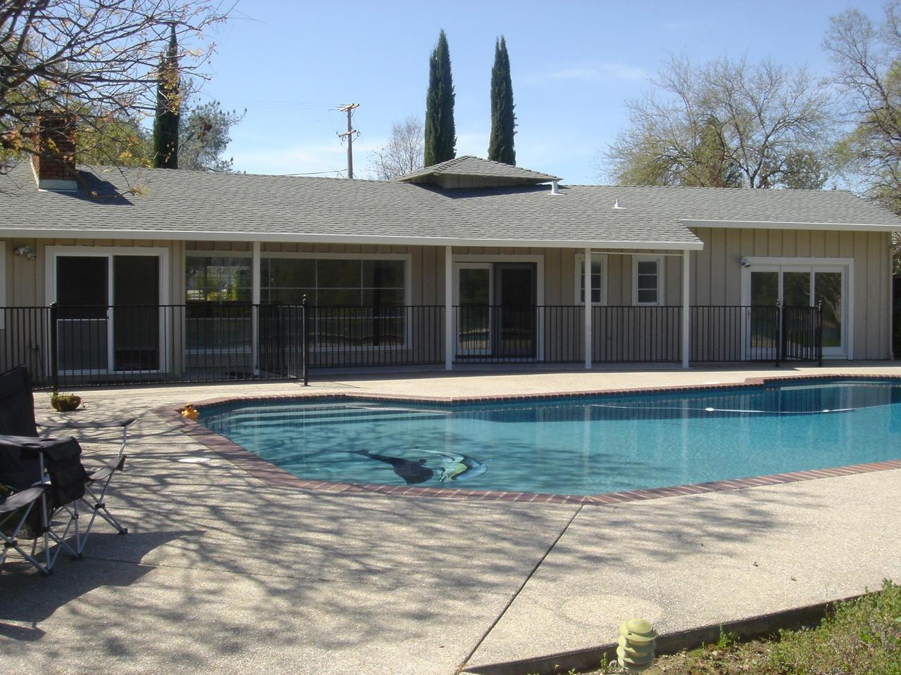 6341 Riverside Drive Redding, CA 96001 - Photo 12 of 20 a front view of a house with a garden