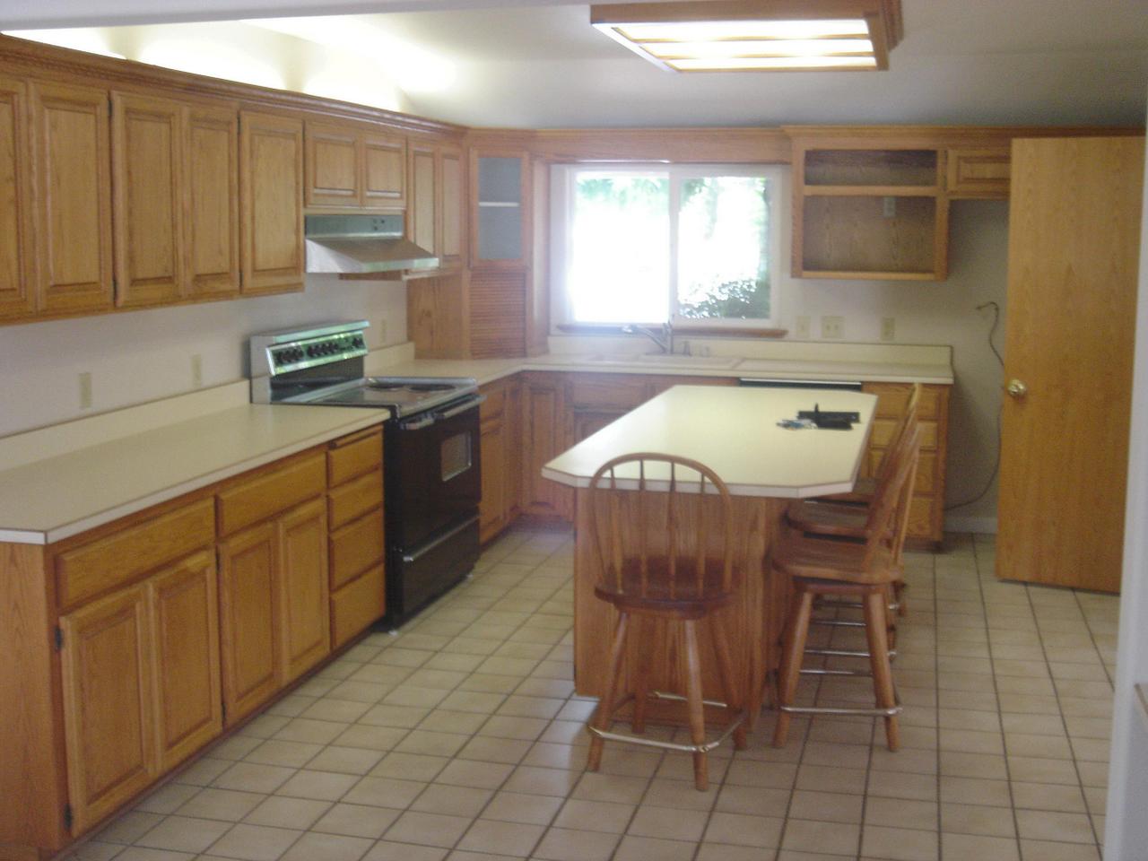 6341 Riverside Drive Redding, CA 96001 - Photo 16 of 20 a kitchen with a sink a window and stainless steel appliances