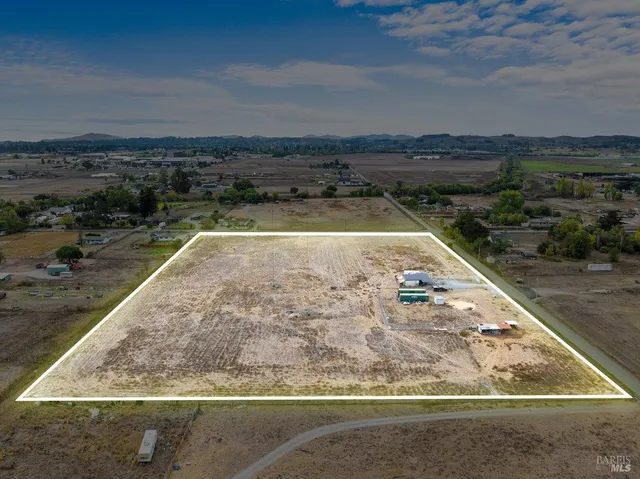 an aerial view of a residential houses with outdoor space