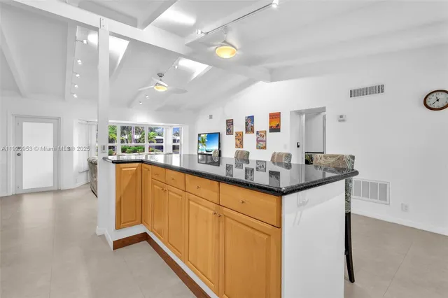 a kitchen with stainless steel appliances granite countertop a stove and a sink