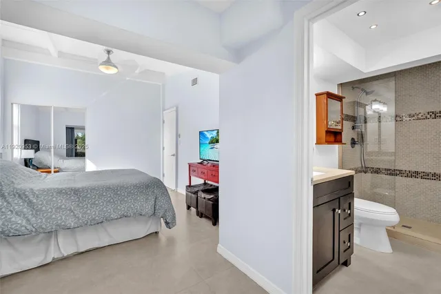 a bathroom with a granite countertop shower a mirror and a sink