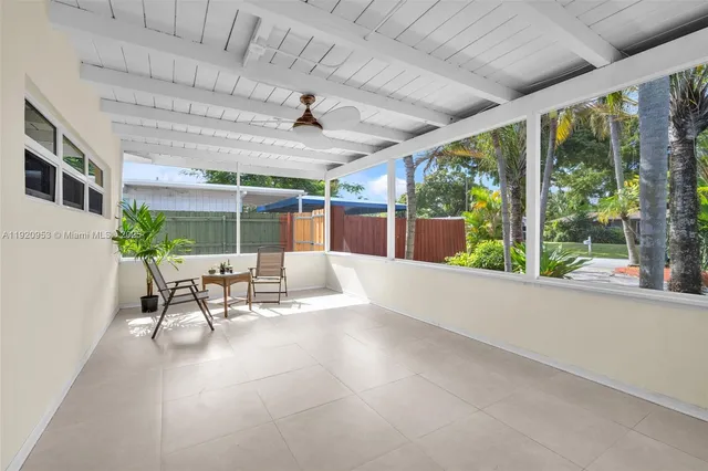 a backyard of a house with barbeque oven table and chairs