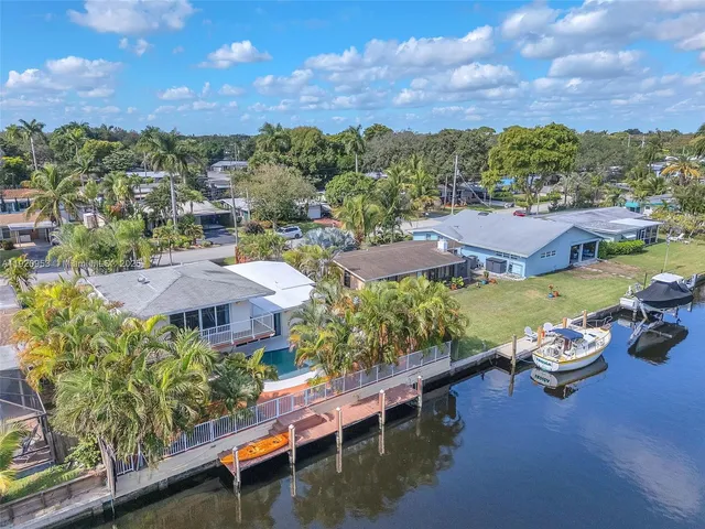 an aerial view of a houses with a lake view