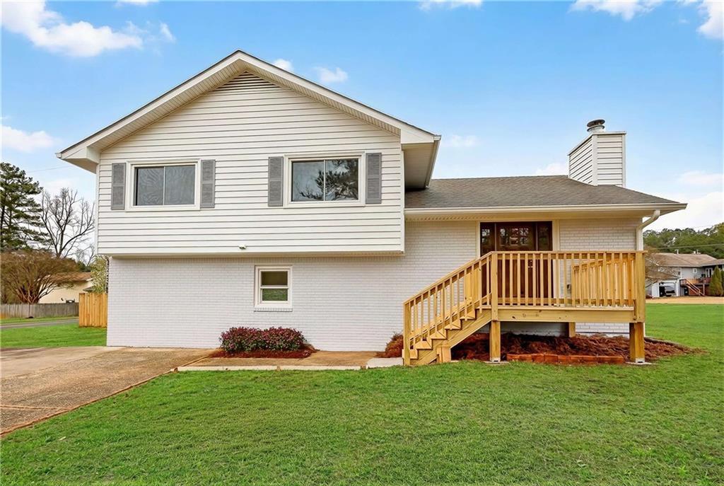 2776 Parcel Road Austell, GA 30106 - Photo 1 of 30 a front view of a house with a garden and deck