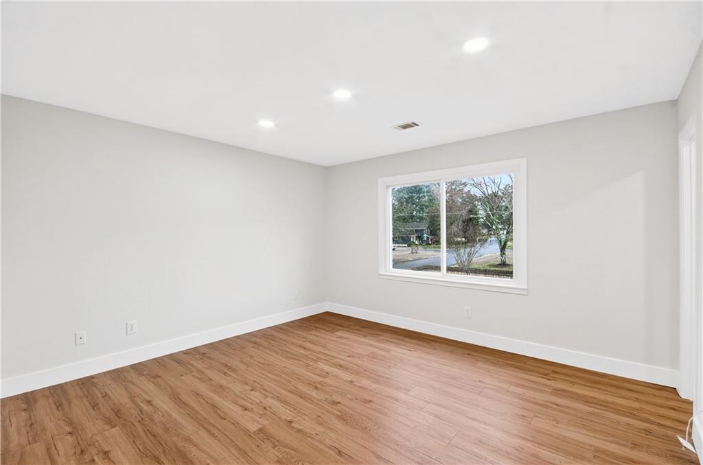 2776 Parcel Road Austell, GA 30106 - Photo 17 of 30 an empty room with wooden floor and windows