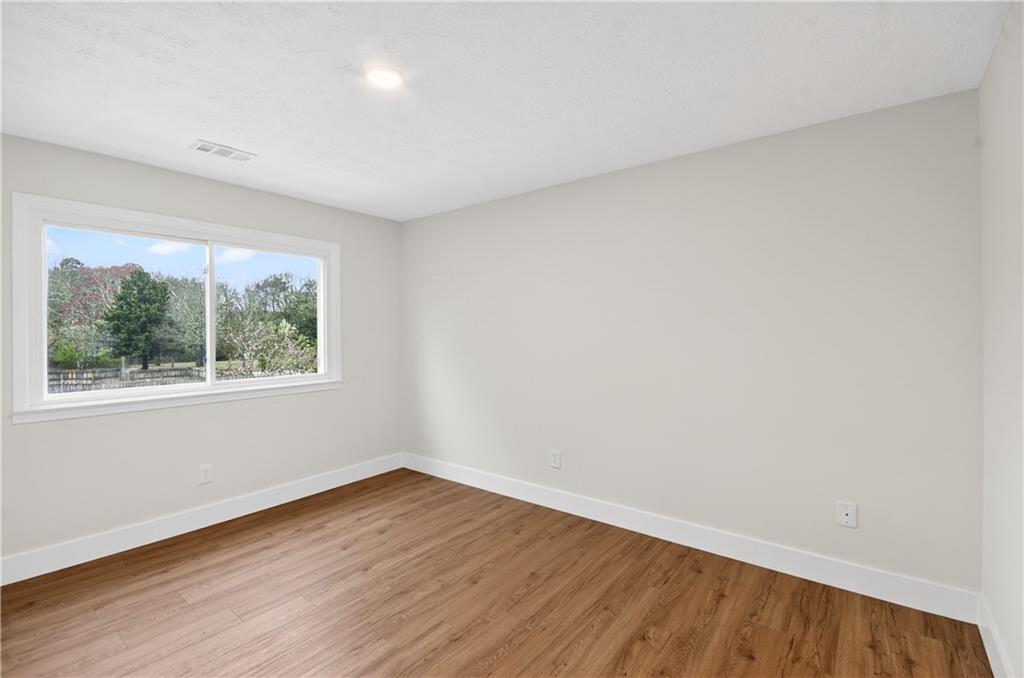 2776 Parcel Road Austell, GA 30106 - Photo 19 of 30 a view of an empty room with wooden floor and a window