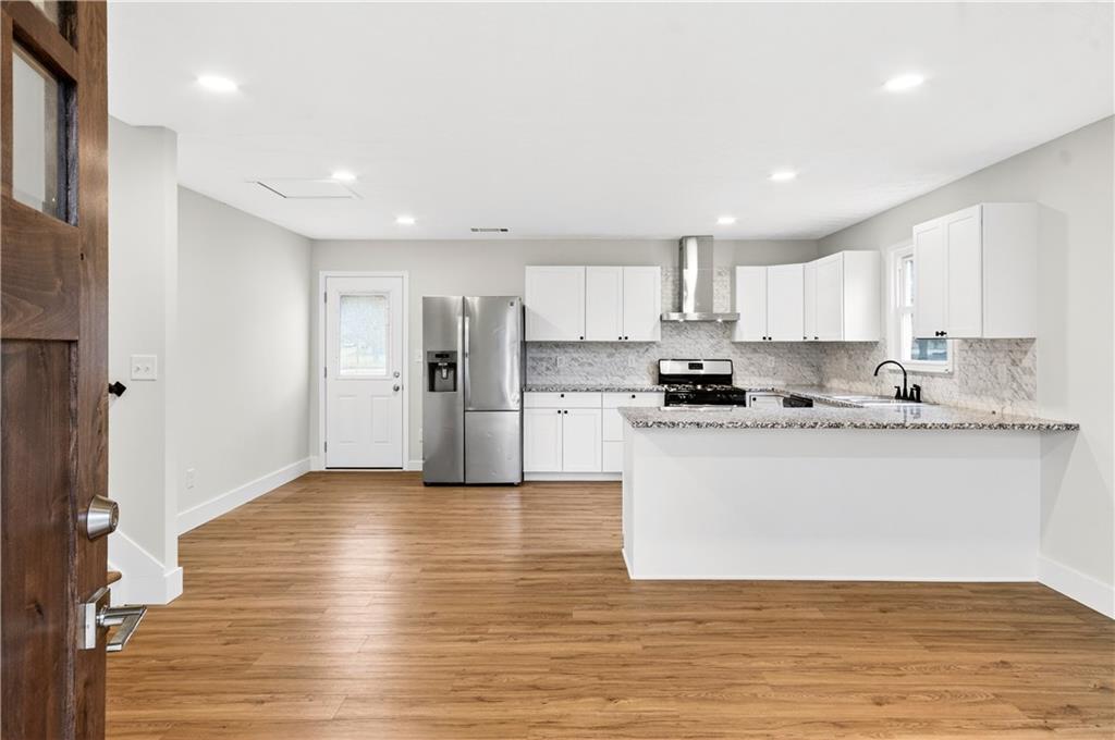 2776 Parcel Road Austell, GA 30106 - Photo 3 of 30 a kitchen with stainless steel appliances granite countertop a refrigerator sink and white cabinets