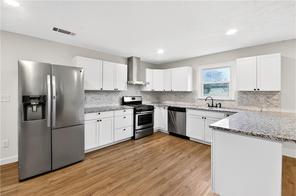 2776 Parcel Road Austell, GA 30106 - Photo 5 of 30 a kitchen with stainless steel appliances granite countertop a refrigerator sink and cabinets