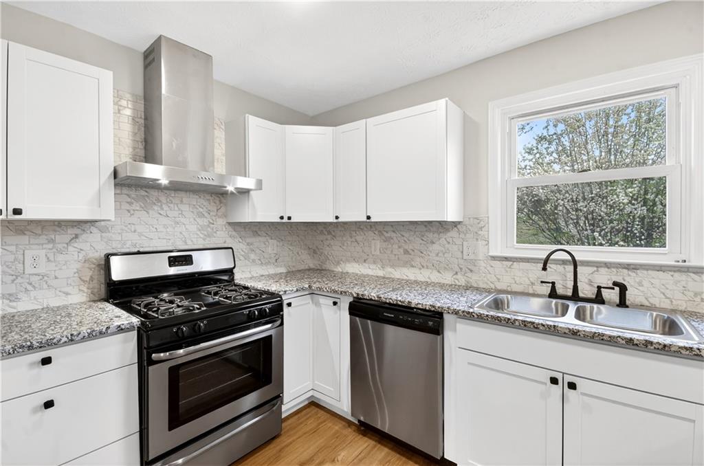 2776 Parcel Road Austell, GA 30106 - Photo 6 of 30 a kitchen with granite countertop white cabinets appliances and a window