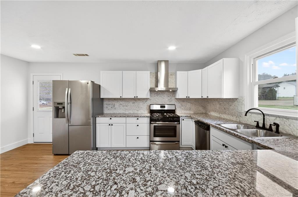2776 Parcel Road Austell, GA 30106 - Photo 8 of 30 a kitchen with stainless steel appliances granite countertop a refrigerator sink and stove