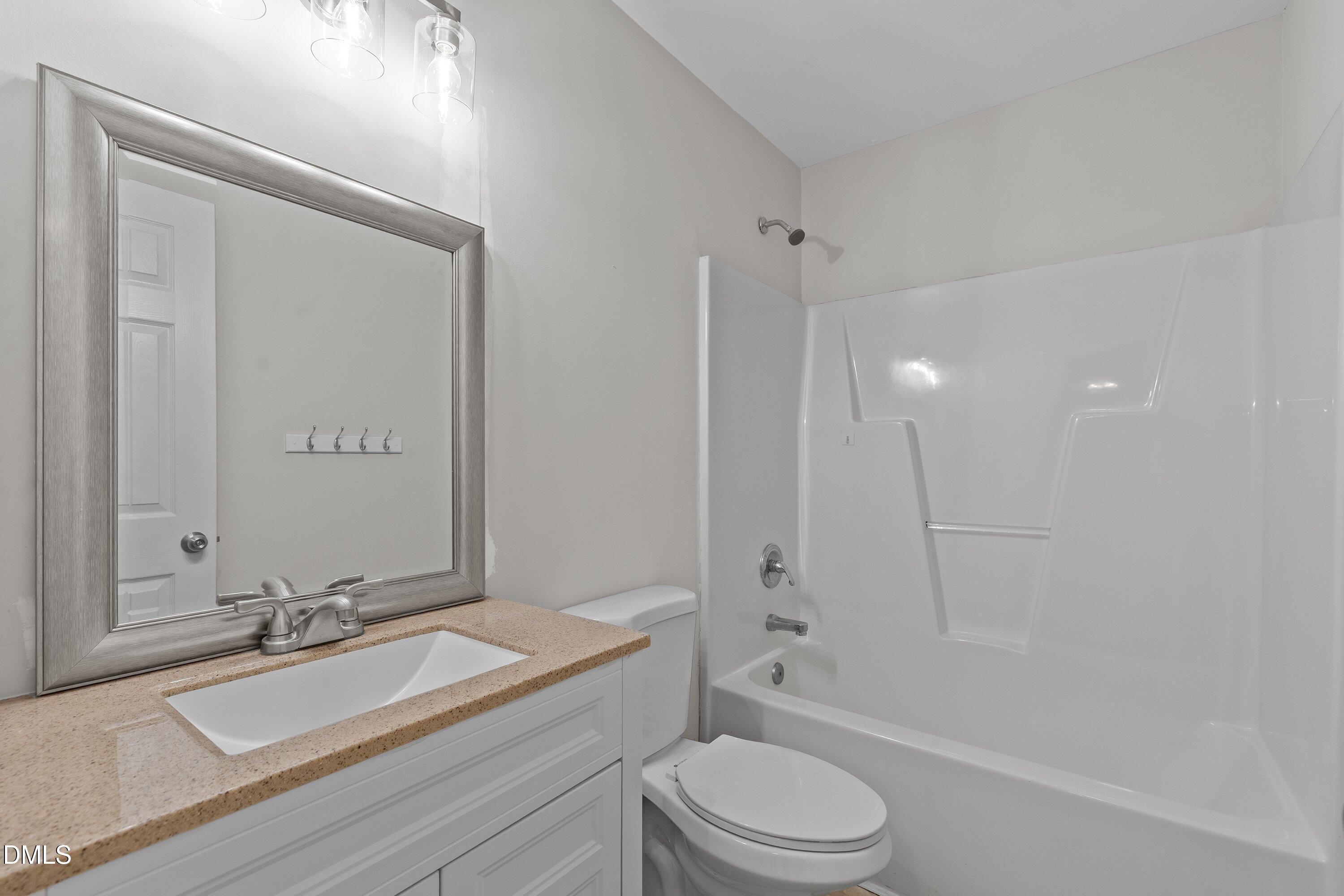 140 Melksham Road Wake Forest, NC 27587 - Photo 26 of 34 a bathroom with a granite countertop sink toilet and shower