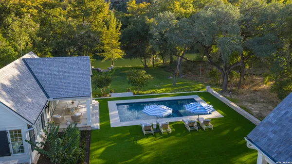 an aerial view of a chairs and table in the patio