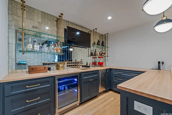 a kitchen with a sink a stove and cabinets