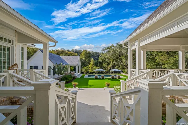 a view of backyard with swimming pool and outdoor seating