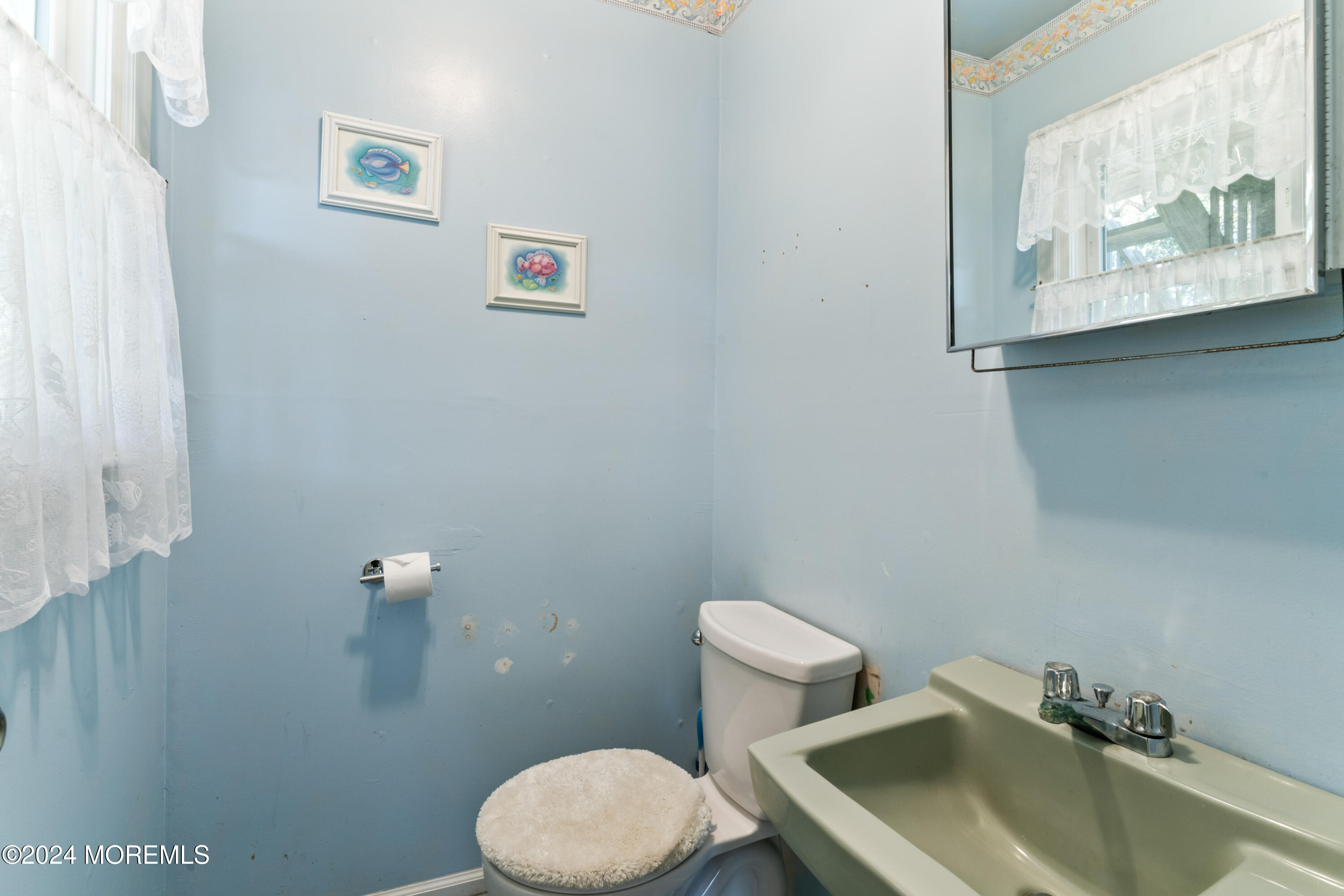 407 Reedy Drive Brick, NJ 08723 - Photo 25 of 35 a white toilet sitting next to a bathroom sink