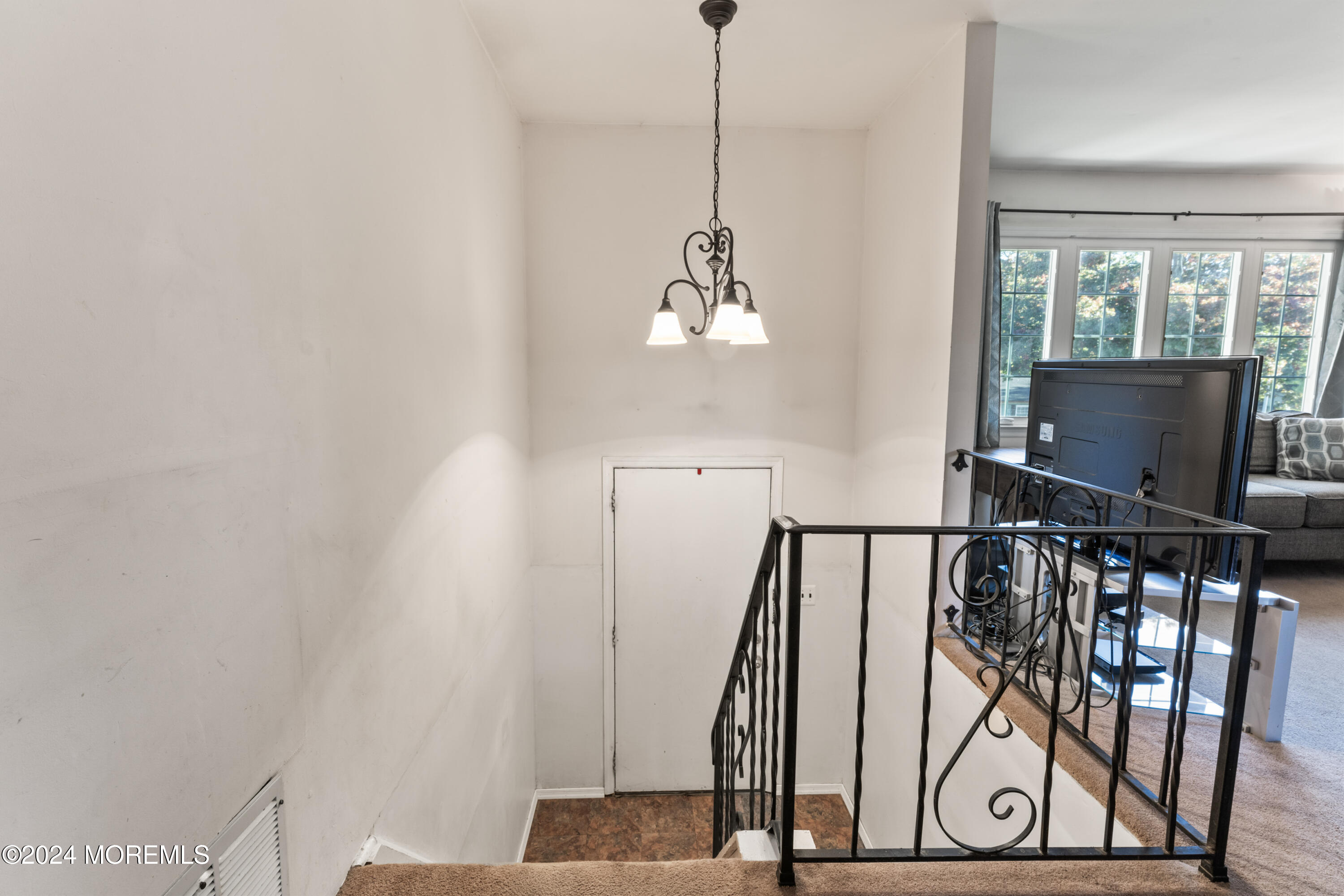 407 Reedy Drive Brick, NJ 08723 - Photo 3 of 35 a view of a hallway with wooden floor and stairs