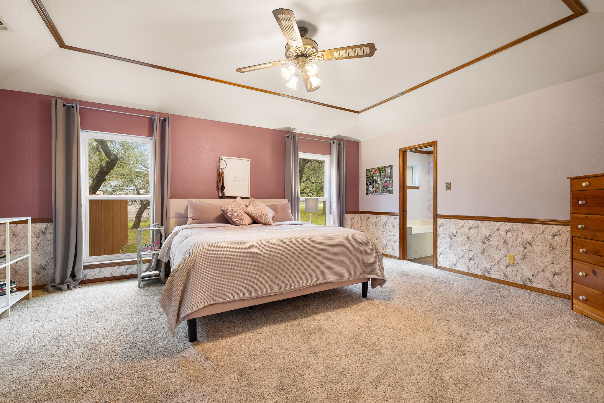 136 Valley View Road Georgetown, TX 78633 - Photo 18 of 40 Super spacious primary bedroom with plenty of natural light, young carpet and a ceiling fan.