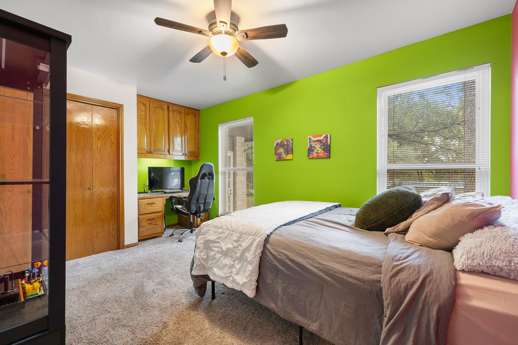 136 Valley View Road Georgetown, TX 78633 - Photo 24 of 40 One of the secondary bedrooms has a built-in desk and cabinetry as well as a closet. And of course there is a ceiling fan, young carpet and a view of the pretty yard.