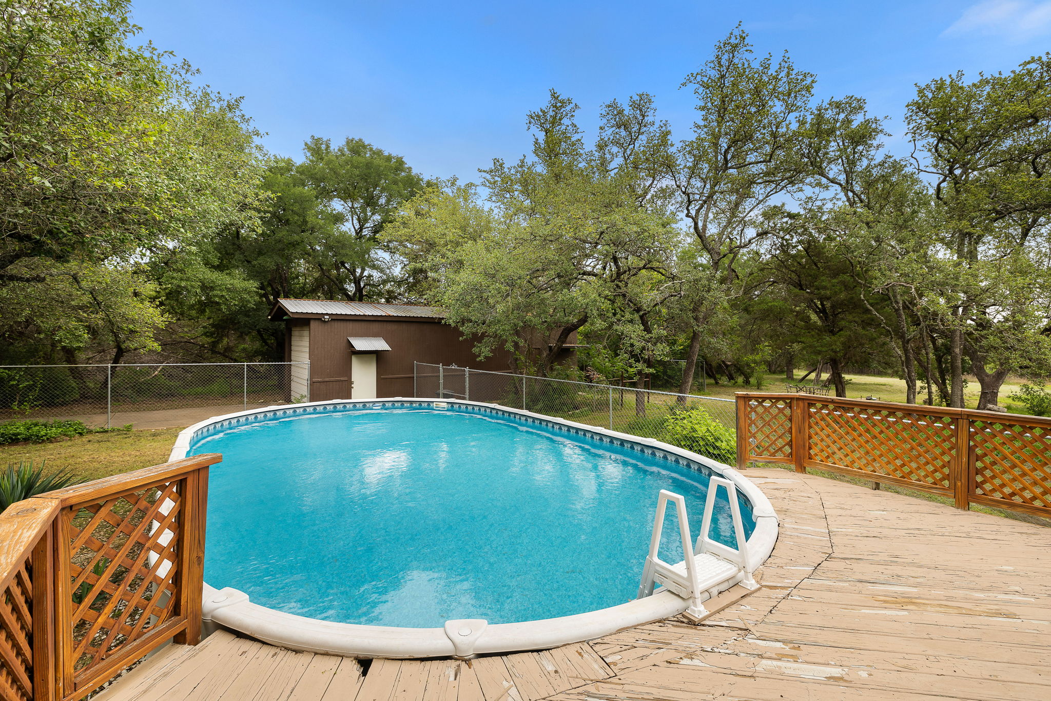 136 Valley View Road Georgetown, TX 78633 - Photo 30 of 40 This above-ground pool has a new sand filter and pump as of 2023 as well as a great deck (with a view!) on which to sunbathe!