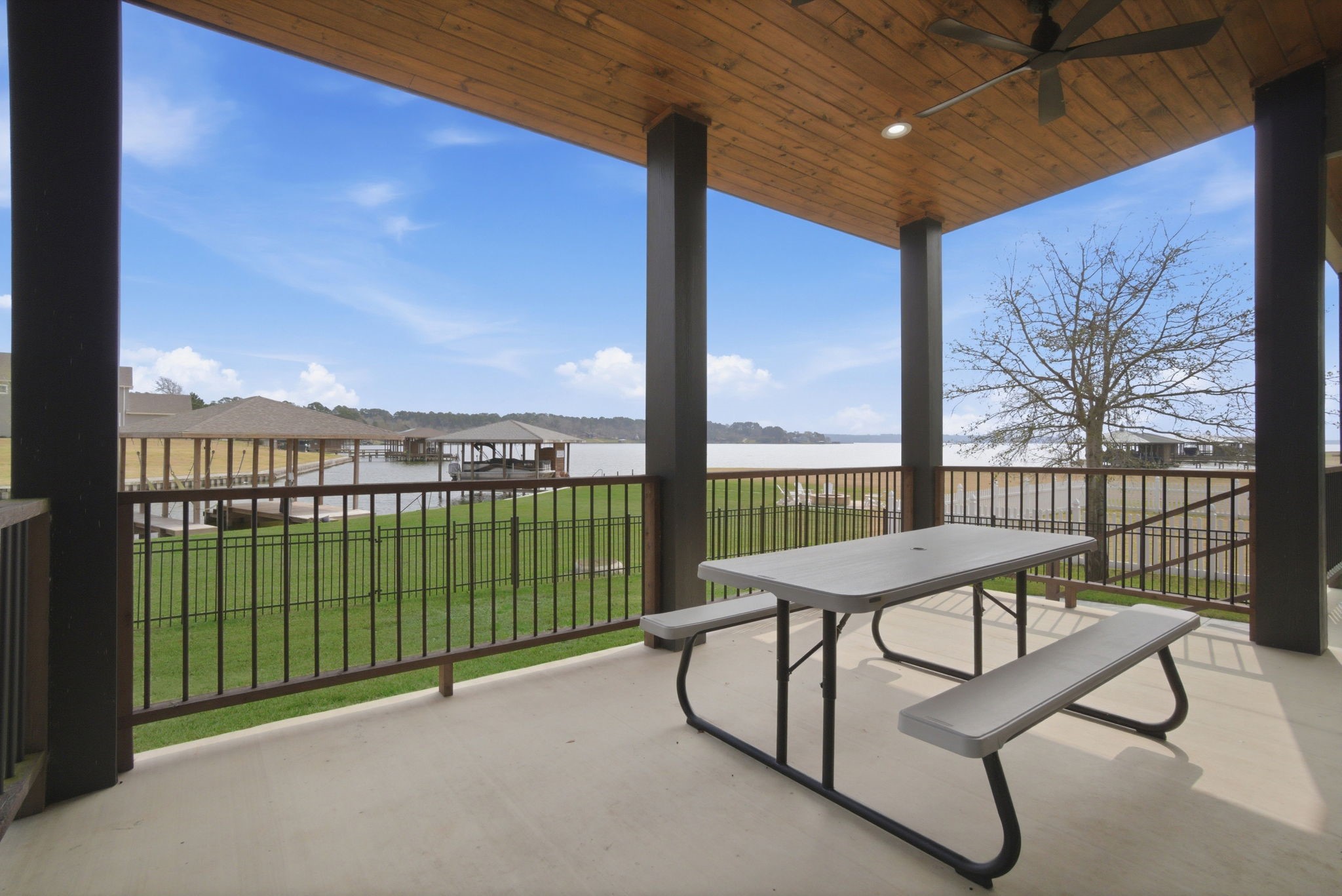 255 Peninsula Drive Livingston, TX 77351 - Photo 3 of 50 Beautiful view from one of the two patios provide ample room to relax or entertain as you take in the view, while the three ceiling fans in the custom wood porch ceiling keep you
and your guests cool.