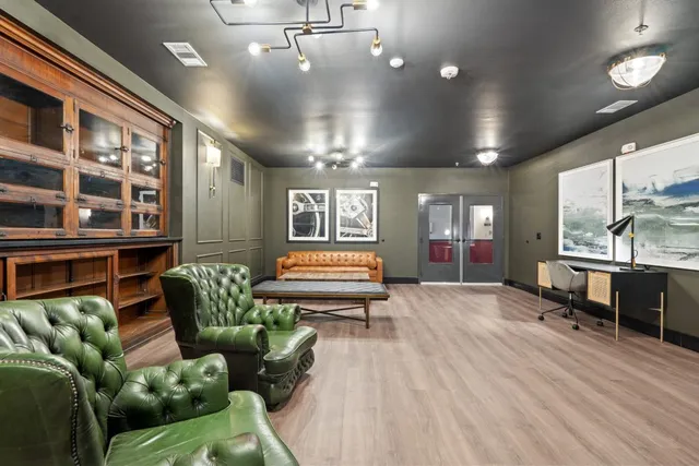 a living room with furniture rug and wooden floor