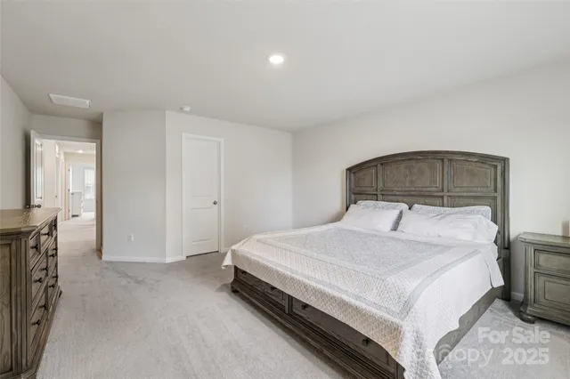 a spacious bedroom with a bed and a tv