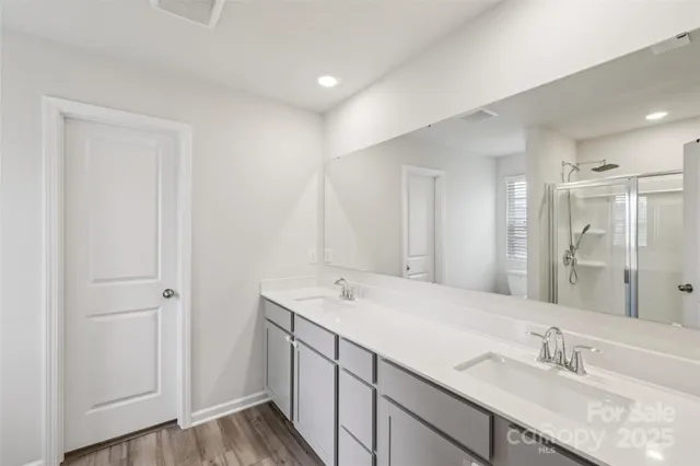 a bathroom with a double vanity sink and a mirror