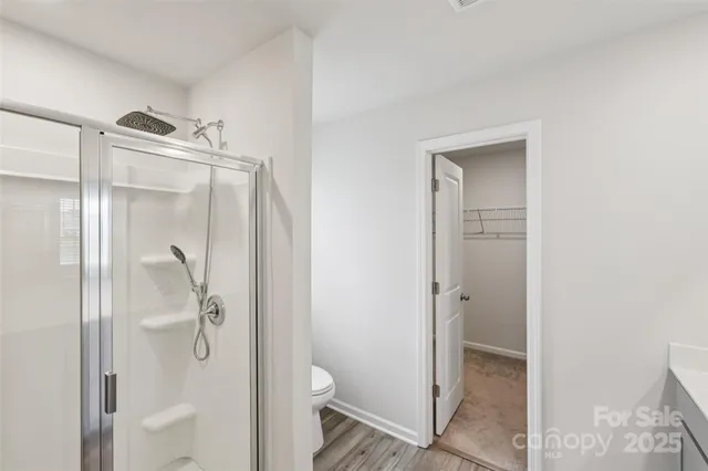 a bathroom with a shower and toilet