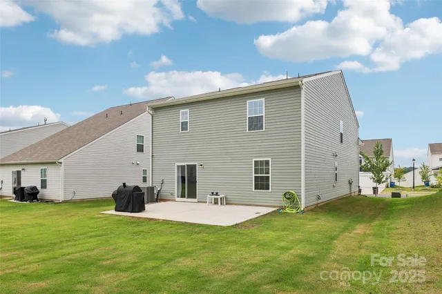 a view of a house with pool and chairs