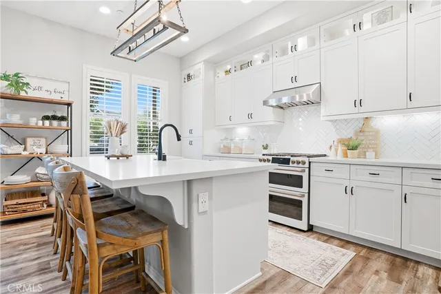 a kitchen with a stove a sink and a refrigerator
