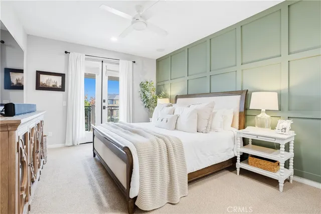 a bathroom with a granite countertop sink a mirror a potted plant and a shower