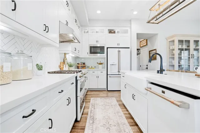 a kitchen with counter top space and painting on the wall