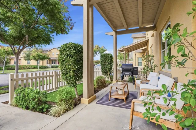 a view of a house with backyard sitting area and garden