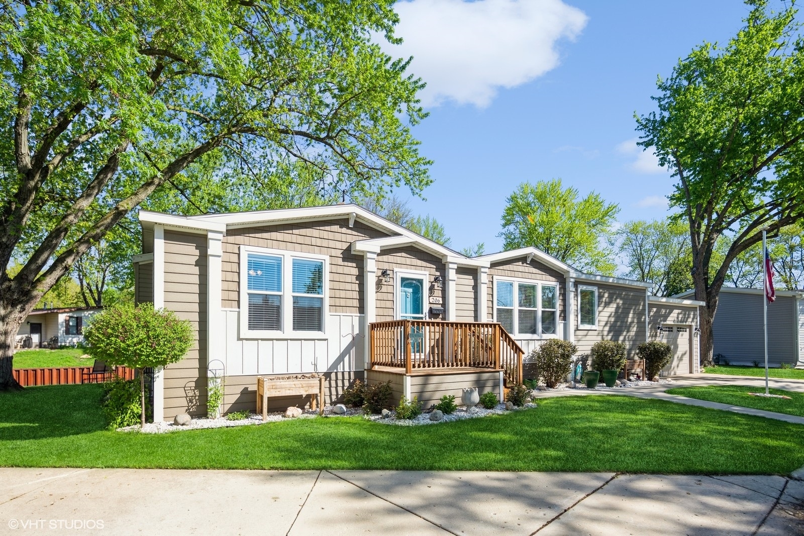 206 Big Peninsula Road Elgin, IL 60123 - Photo 1 of 23 a front view of a house with a garden