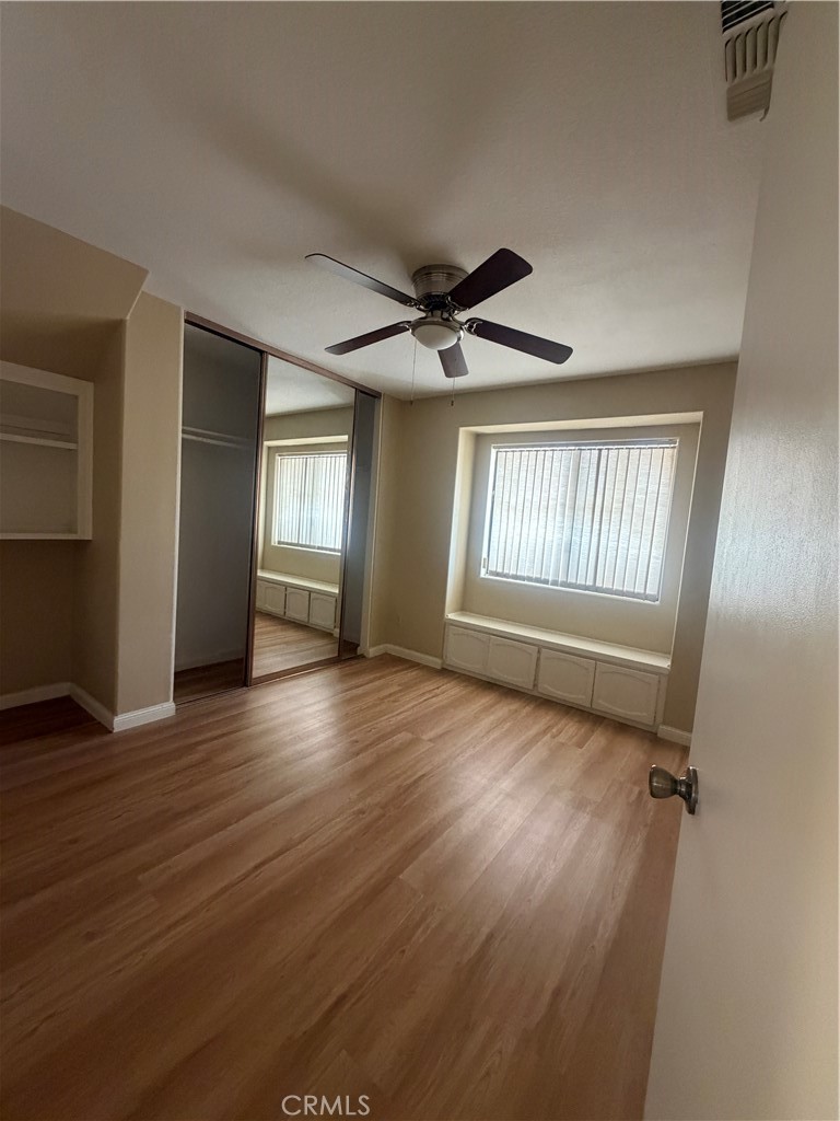 19609 Seneca Road Apple Valley, CA 92307 - Photo 27 of 37 an empty room with wooden floor and windows