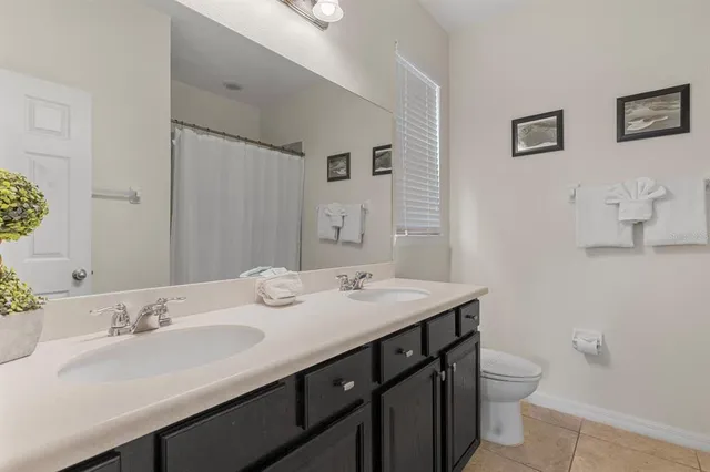 a bathroom with a sink double vanity and a toilet