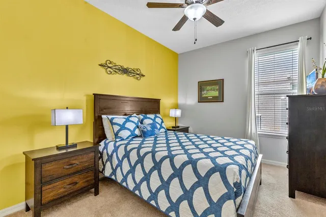 a bedroom with a bed and lamps