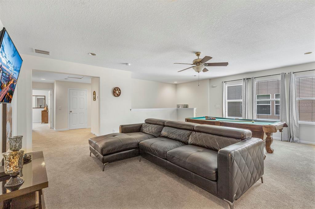 946 Suffolk Place Davenport, FL 33896 - Photo 17 of 41 a living room with furniture and a ceiling fan