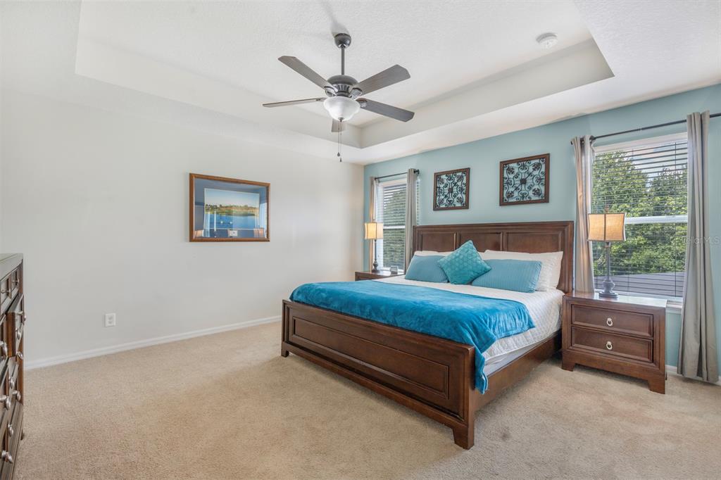 946 Suffolk Place Davenport, FL 33896 - Photo 19 of 41 a spacious bedroom with a bed and a window