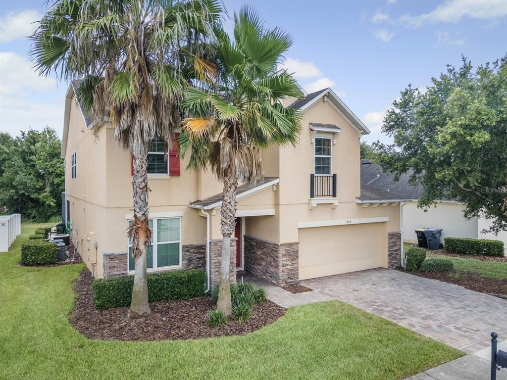 946 Suffolk Place Davenport, FL 33896 - Photo 2 of 41 a view of house with a yard and potted plants