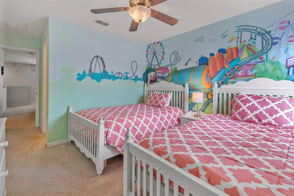 946 Suffolk Place Davenport, FL 33896 - Photo 26 of 41 a bedroom with a bed and a chandelier