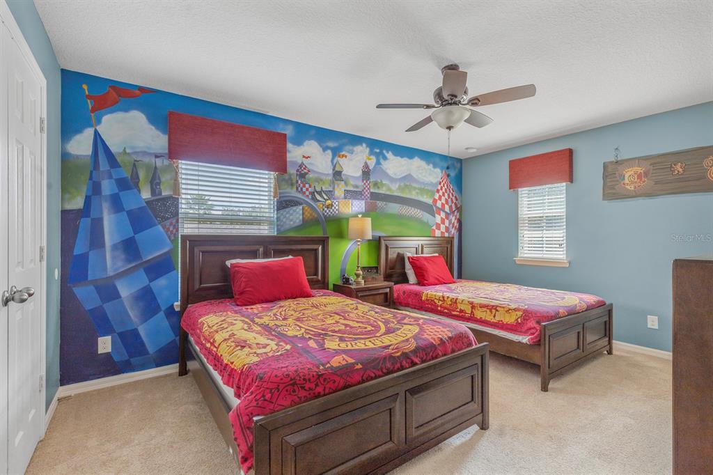 946 Suffolk Place Davenport, FL 33896 - Photo 28 of 41 a bedroom with a bed a dresser next to a window