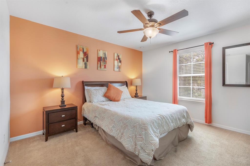 946 Suffolk Place Davenport, FL 33896 - Photo 31 of 41 a bedroom with a bed and window