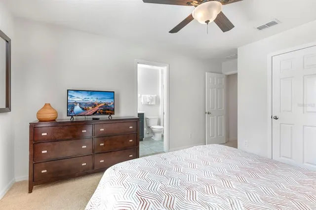 a bedroom with a bed and a dresser