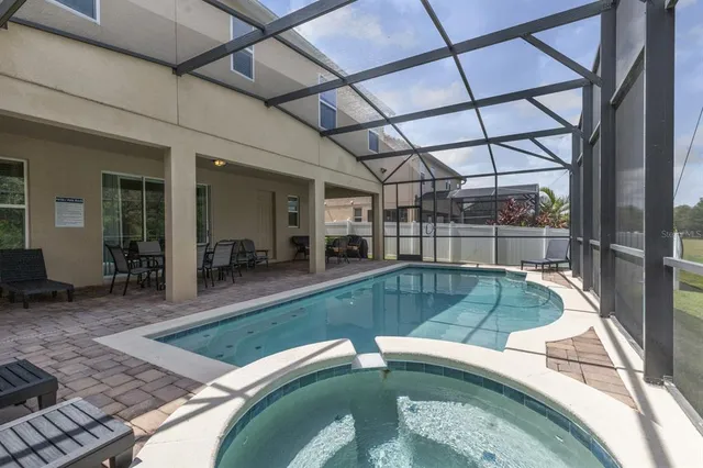 a view of a swimming pool with a patio