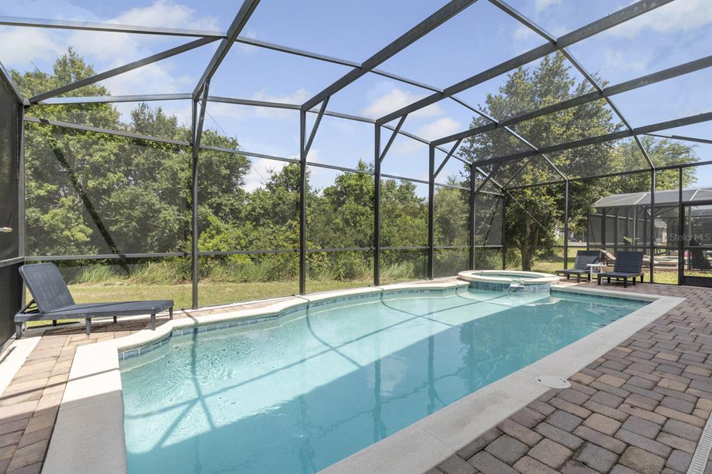 946 Suffolk Place Davenport, FL 33896 - Photo 4 of 41 a view of a swimming pool with a patio and a yard