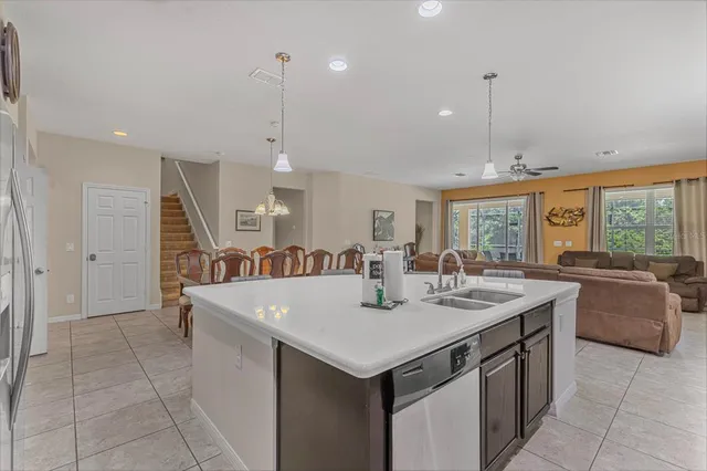 a large kitchen with kitchen island a sink a counter space appliances and cabinets