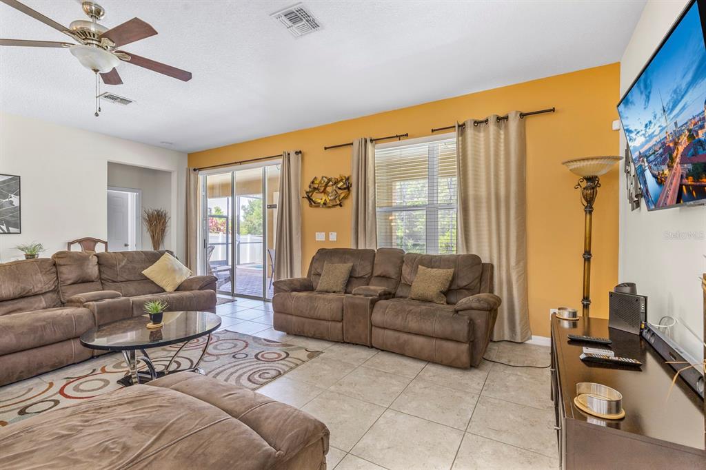 946 Suffolk Place Davenport, FL 33896 - Photo 10 of 41 a living room with furniture and a large window
