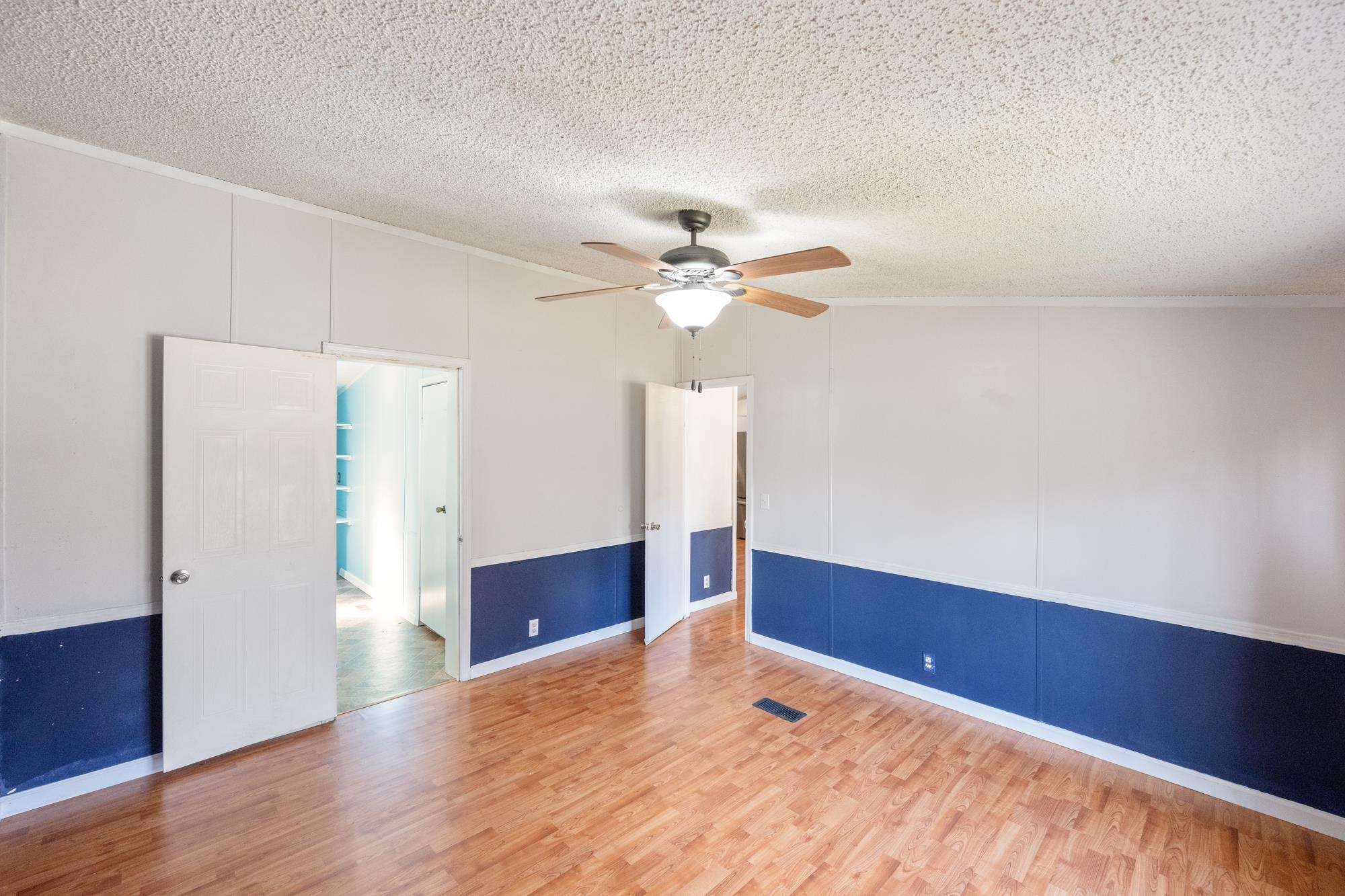 875 Lindsey Road Parsons, TN 38363 - Photo 12 of 38 a view of a livingroom with a ceiling fan and wooden floor
