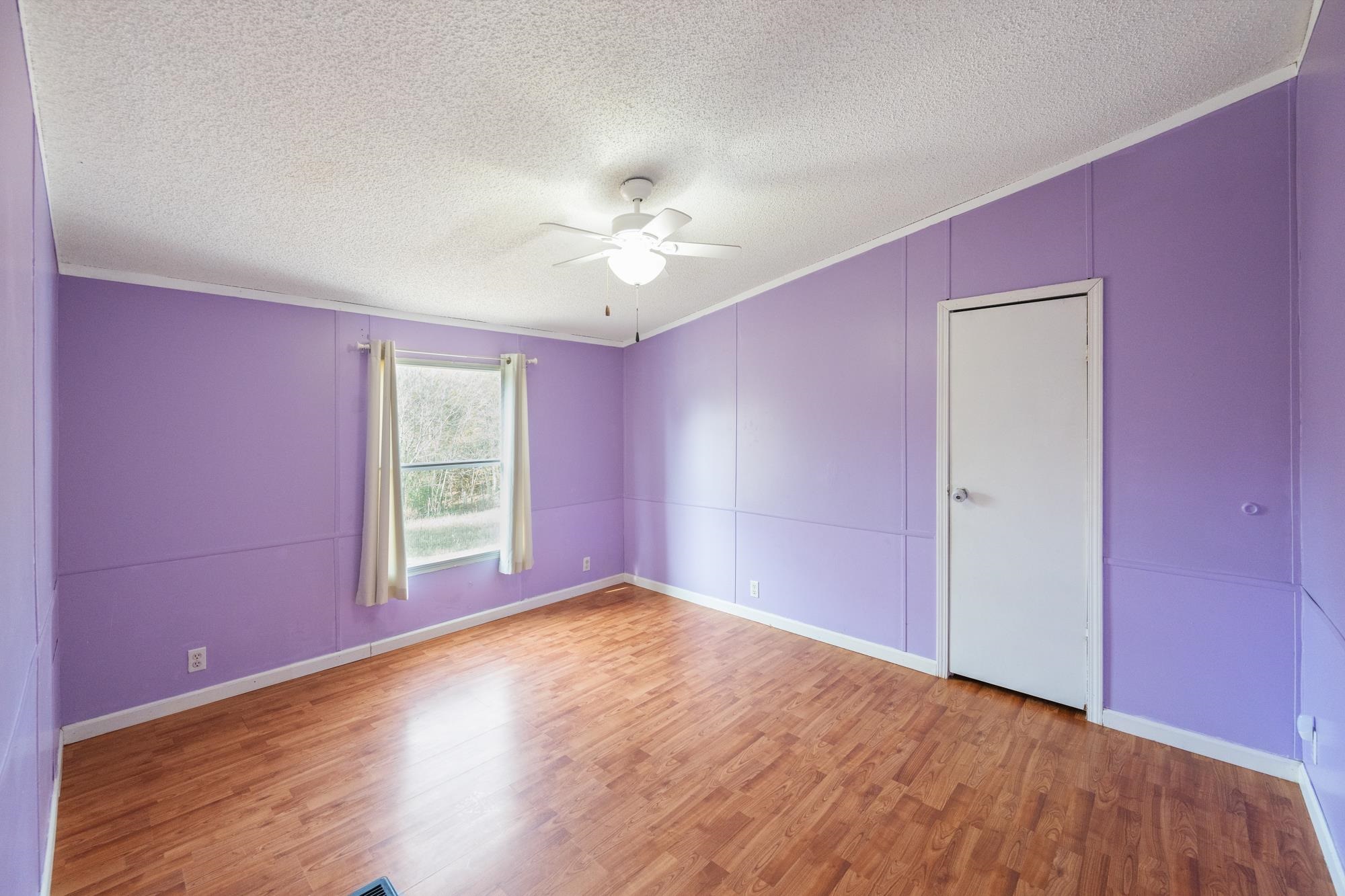 875 Lindsey Road Parsons, TN 38363 - Photo 14 of 38 wooden floor in an empty room with a window